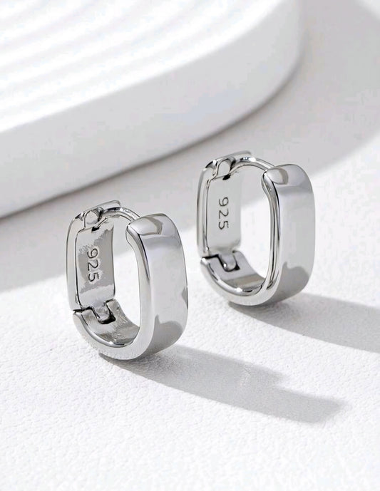 Silver hoop earrings with '925' stamp on a white background