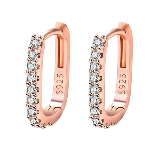 Rose gold hoop earrings with clear gemstones on a white background