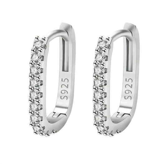 Pair of silver hoop earrings with clear stones on a white background