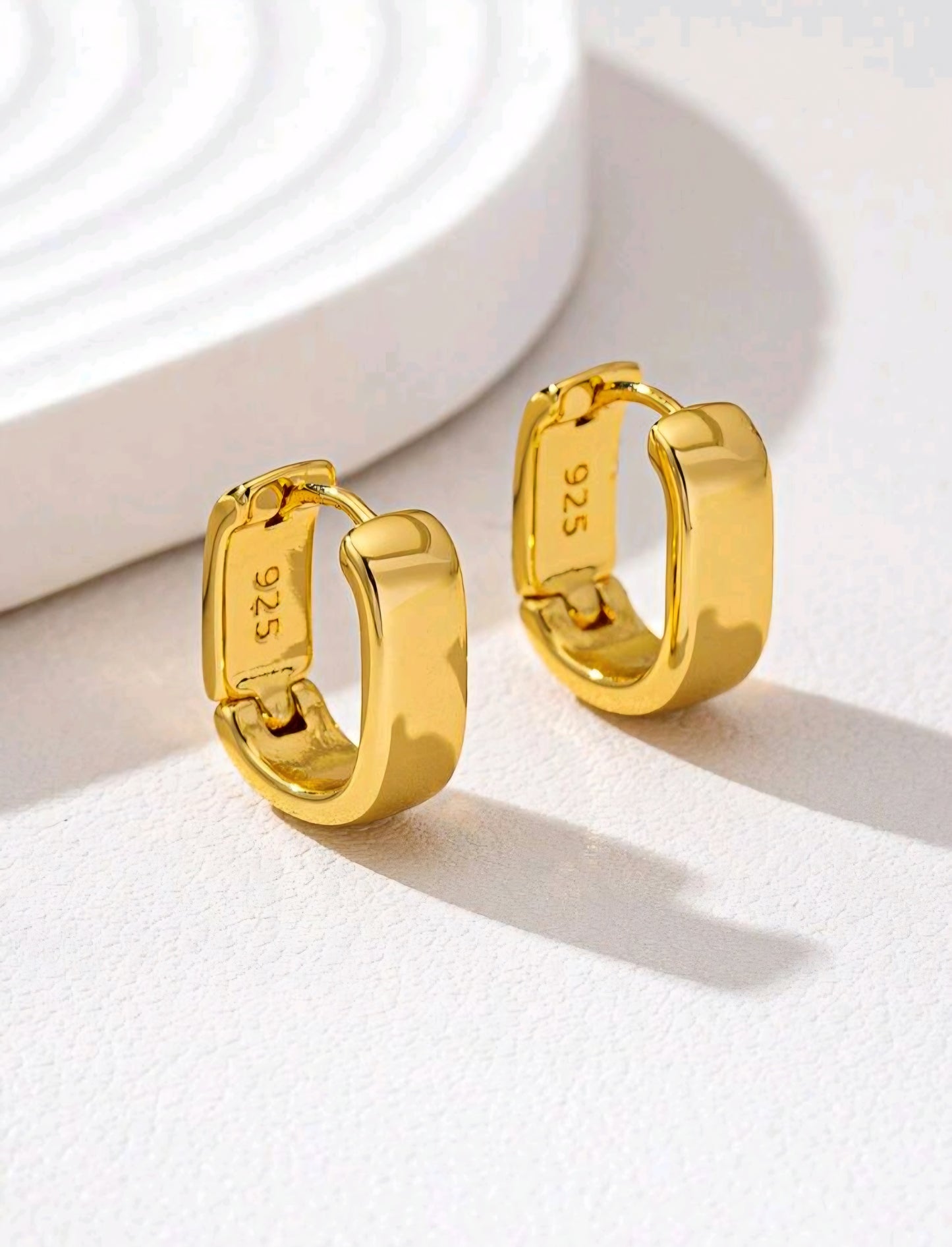 Gold hoop earrings on a white background
